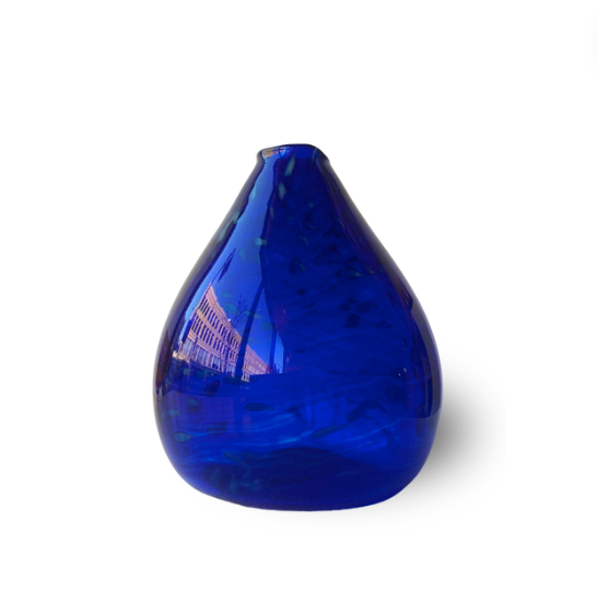 A vibrant cobalt blue glass vase with a rounded, teardrop shape.