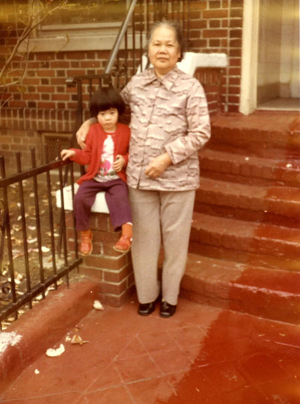 Artist Betty Yu and her grandma, Kam Tze in front of their home in Sunset Park, Brooklyn (circa 1981)