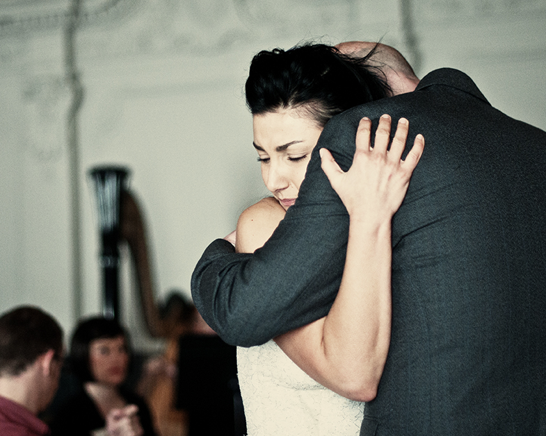 Soprano Miranda Sinani on the shoulder of baritone Paul Keohone in the Ballroom at Sloans (Glasgow, UK). Photo credit: Neil Thomas Douglas.
