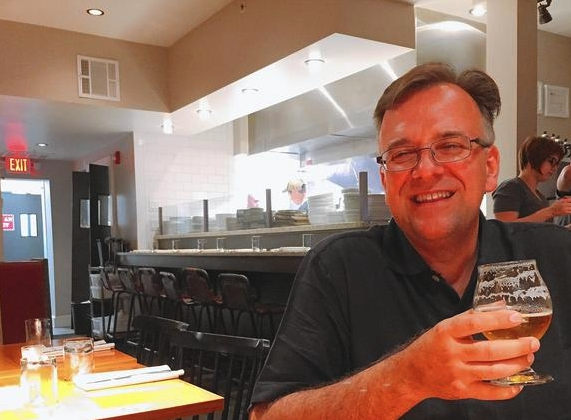 Joe Barsin enjoying a beer at Preserve in downtown Annapolis. He's half the creative force behind some of the best looking beer labels around. (Liz Murphy / Corespondent)