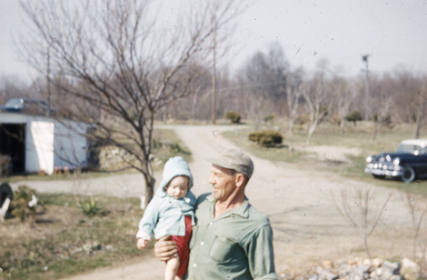 Ralph Perry with his granddaughter Irene in River Crest Farm's early days.