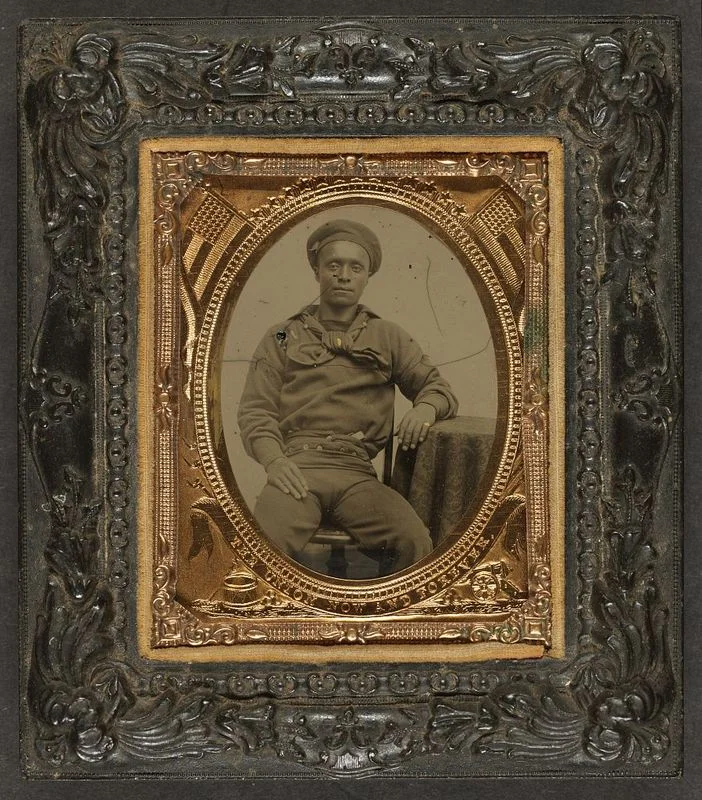 “Unidentified African American sailor in Union uniform sitting with arm resting on table,” Woodson Research Center - Fondren Library - Rice University , Link .
Normal
0
false
false
false
EN-US
X-NONE
X-NONE
/* Style Definitions */
table.MsoNormalTable
{mso-style-name:"Table Normal";
mso-tstyle-rowband-size:0;
mso-tstyle-colband-size:0;
mso-style-noshow:yes;
mso-style-priority:99;
mso-style-parent:"";
mso-padding-alt:0in 5.4pt 0in 5.4pt;
mso-para-margin-top:0in;
mso-para-margin-right:0in;
mso-para-margin-bottom:10.0pt;
mso-para-margin-left:0in;
line-height:115%;
mso-pagination:widow-orphan;
font-size:11.0pt;
font-family:"Calibri","sans-serif";
mso-ascii-font-family:Calibri;
mso-ascii-theme-font:minor-latin;
mso-hansi-font-family:Calibri;
mso-hansi-theme-font:minor-latin;
mso-bidi-font-family:"Times New Roman";
mso-bidi-theme-font:minor-bidi;}