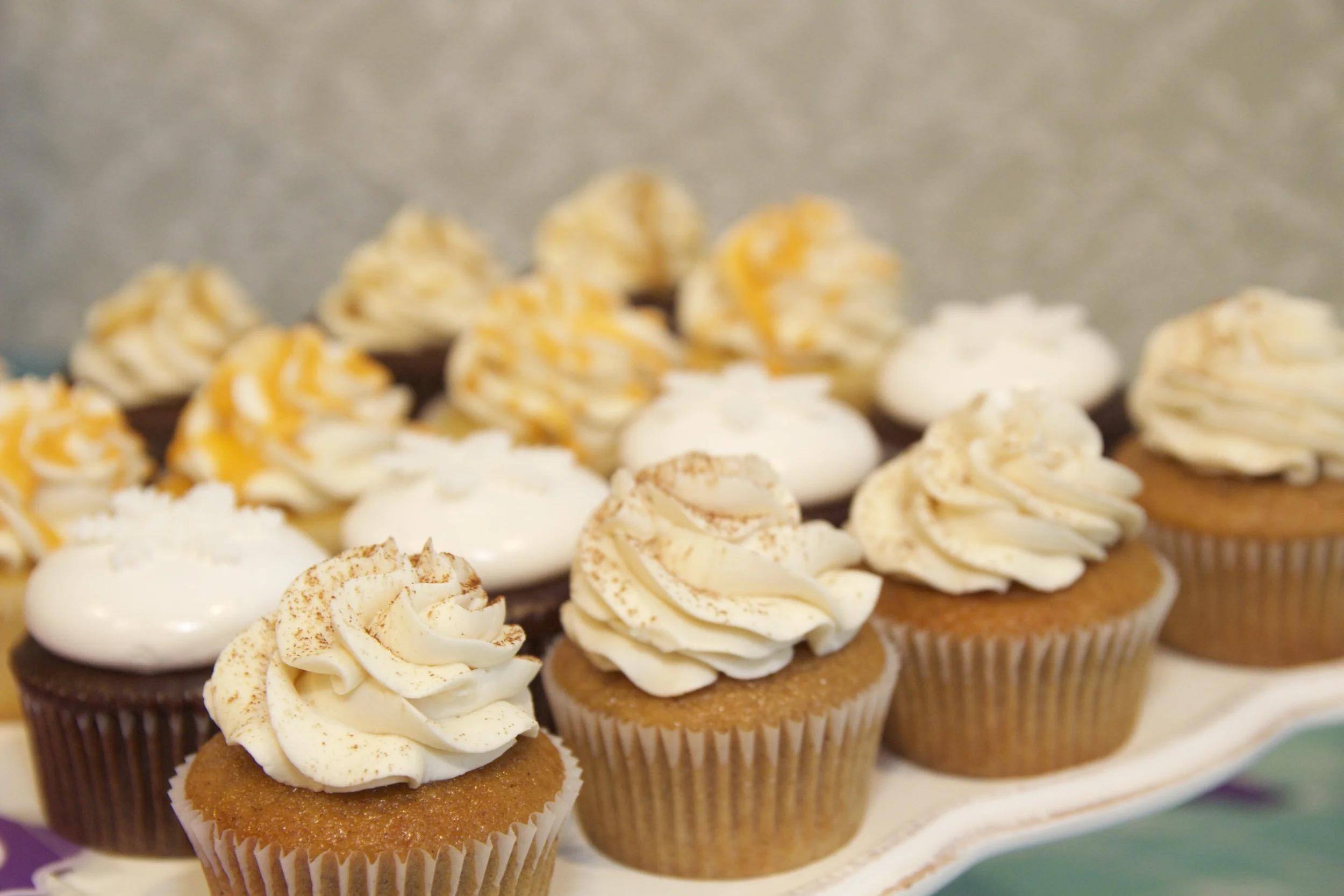 Ginger Spice, Chocolate Ganache topped with homemade marshmallow frosting and fondant snowflakes, Dreamsicle with orange glaze, and Salted Caramel cupcakes 