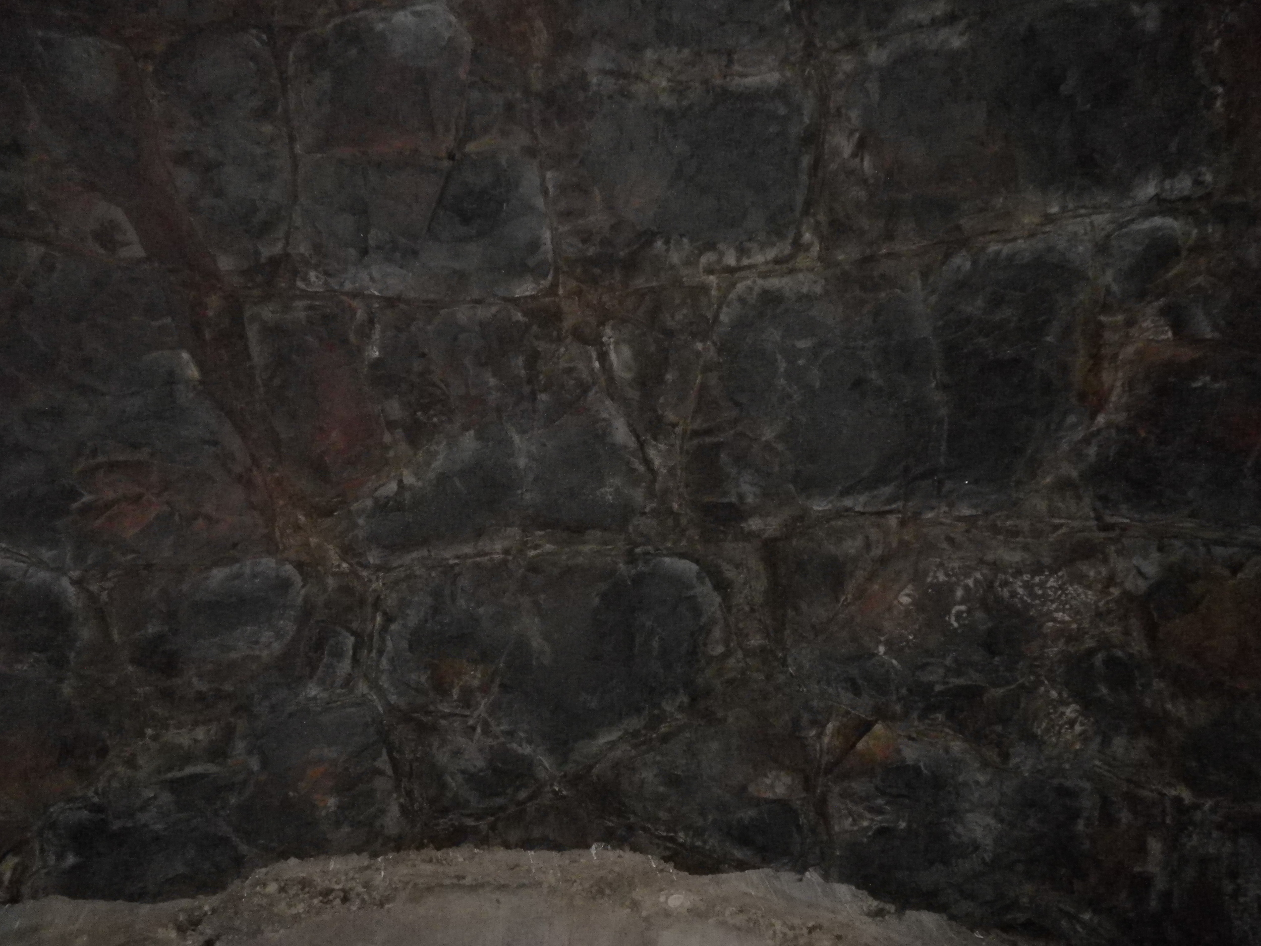 The inside of the tunnel - or what's left of it. Native basalt is visible at the rear of the tunnel. The thin ribbon you see is the remaining concrete that didn't get taken out by the cave-in. Almost certainly unsafe for entry.