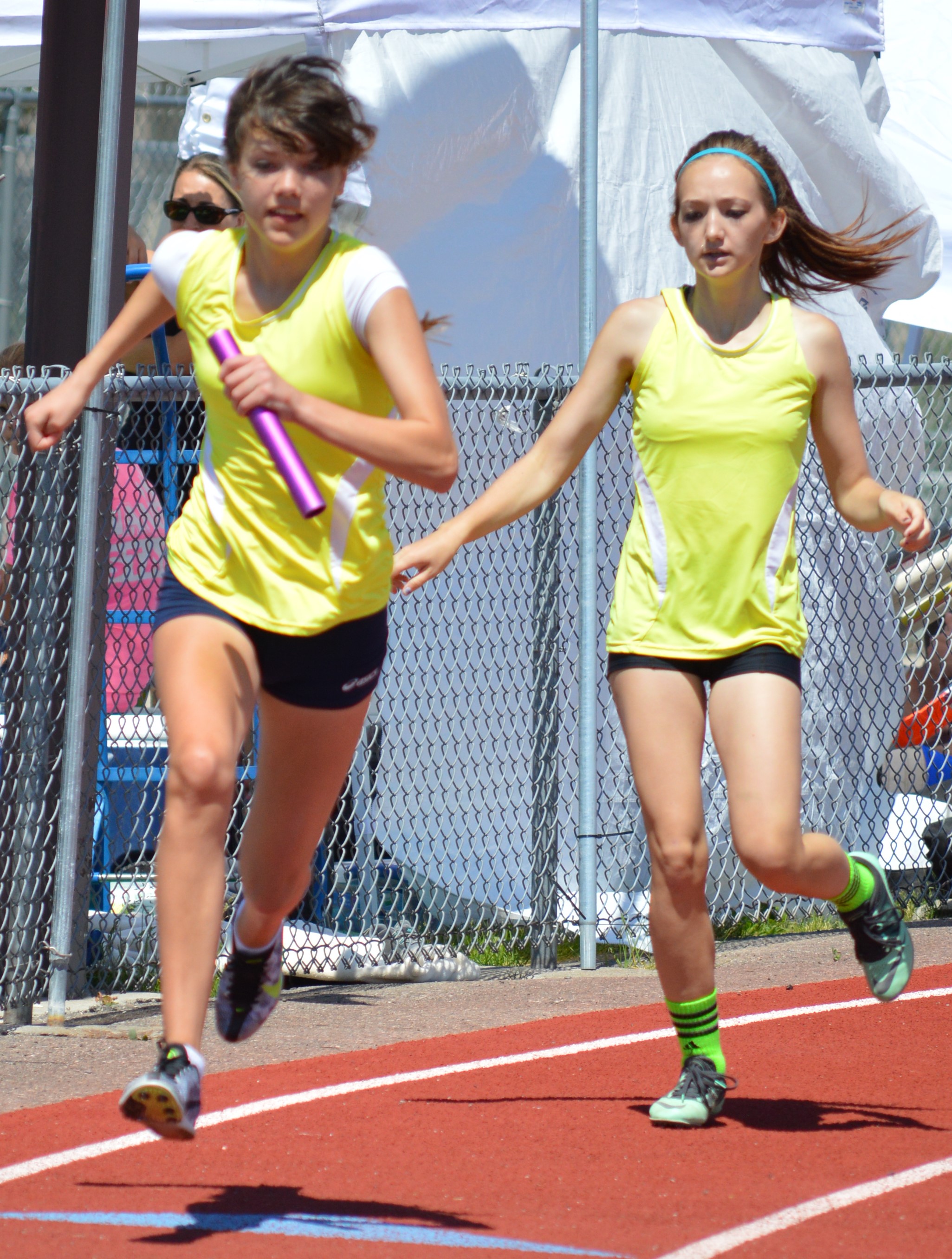 Zoe Robertson launches after getting the baton from Emma Perry