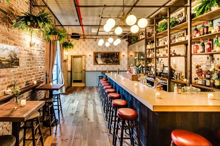 The Reclaimed Oak Flooring in this New York bar consists of old growth planks harvested from big trees long ago. Heritage Oak is pictured along with Vinters Reserve Redwood Wainscoting