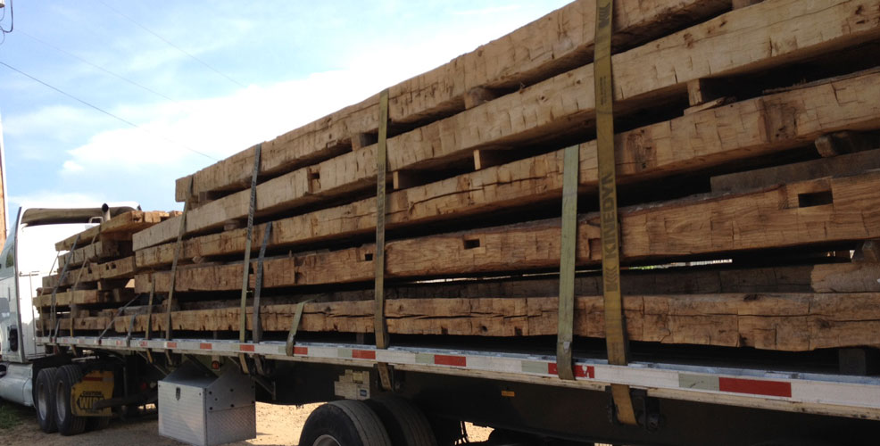 These large hand hewn reclaimed oak beams are rare and have more value than similar reclaimed wood lumber in smaller dimensions. Reclaimed beams can be graded for use in structural applications, too.