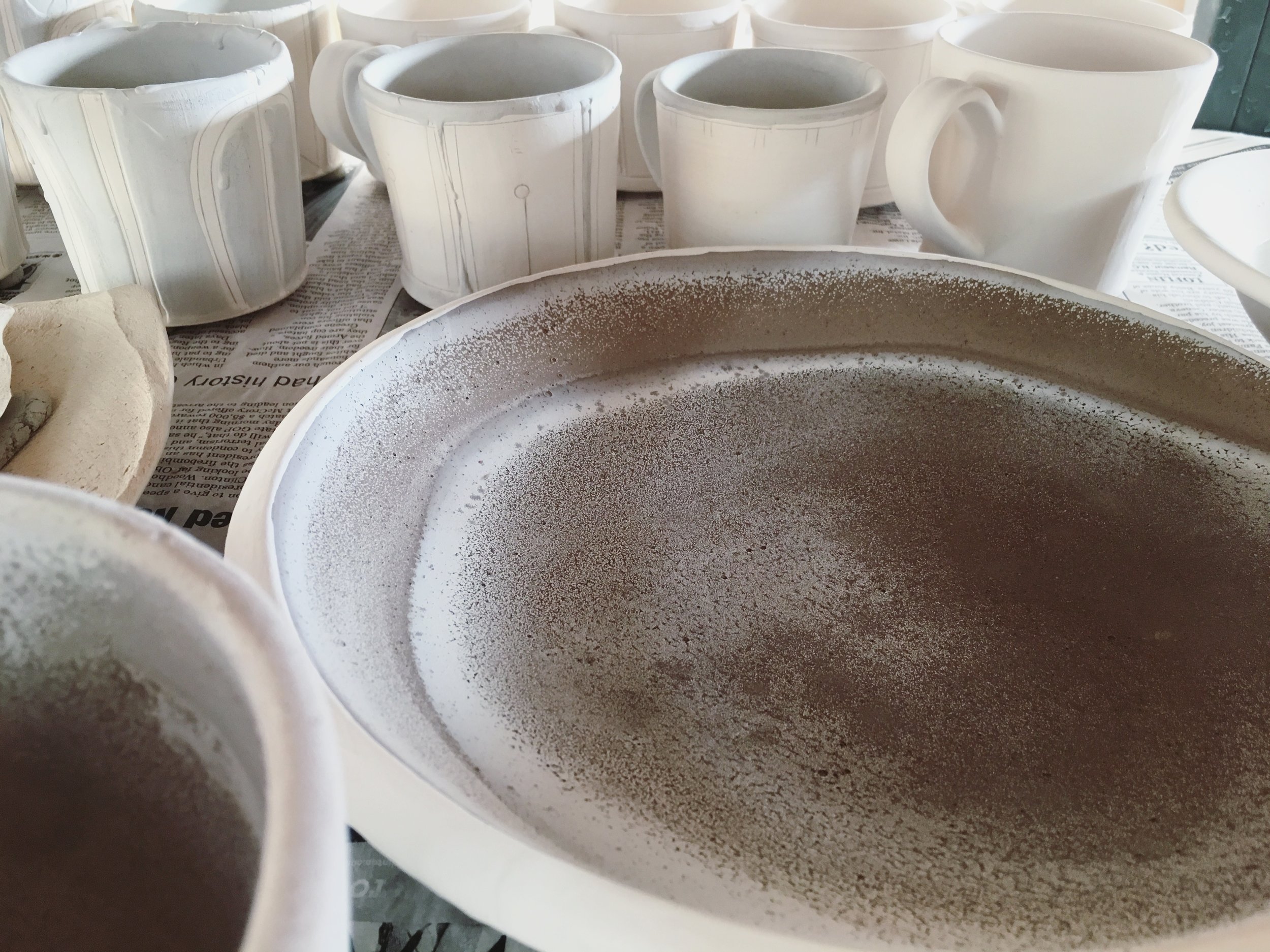 For this place setting, I used a shino glaze which contains soda ash. As the glaze dries, the soda effloresces to the surface creating a unique pattern and even more interesting glazed surface.