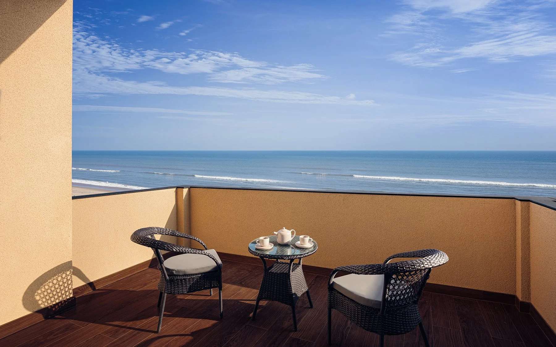 This is a hotel room balcony beach facing. A tea experience awaits with beach view. Serene morning light.