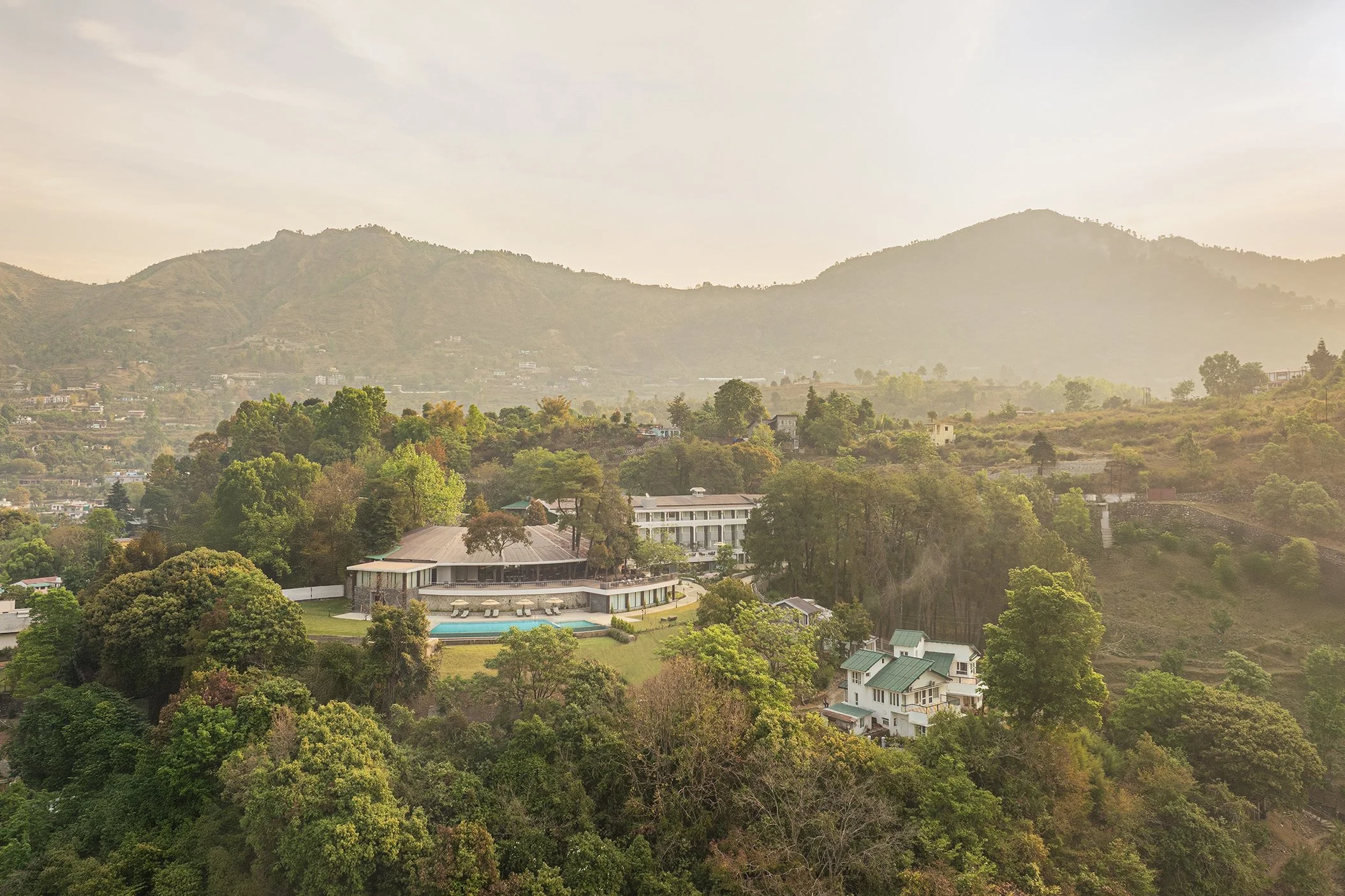 Naukuchia House by IHCL SeleQtions — a hillside retreat in Naukuchiatal, where the pool meets the pines and the Kumaon hills fade into haze.