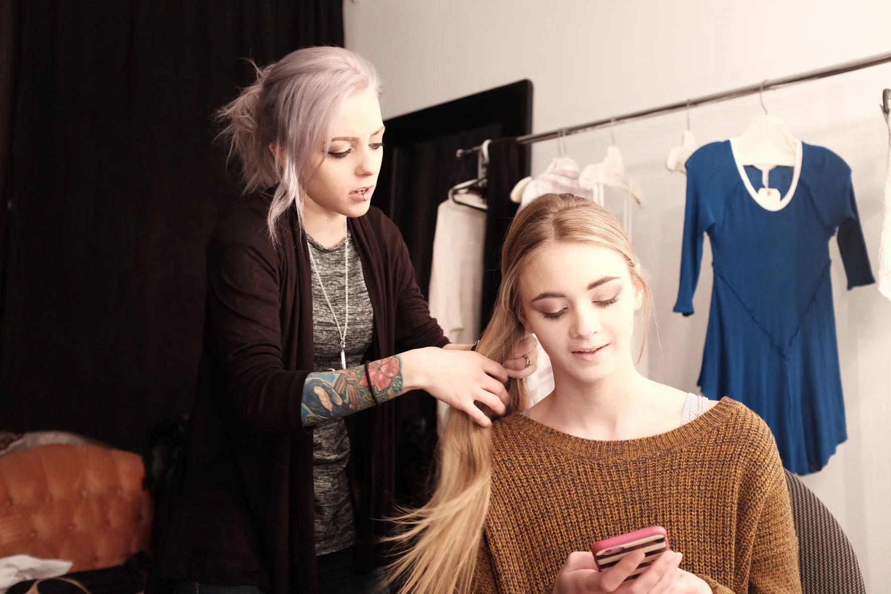 Kelly doing up a fishtail braid for Shannon's long-sweater look. 
