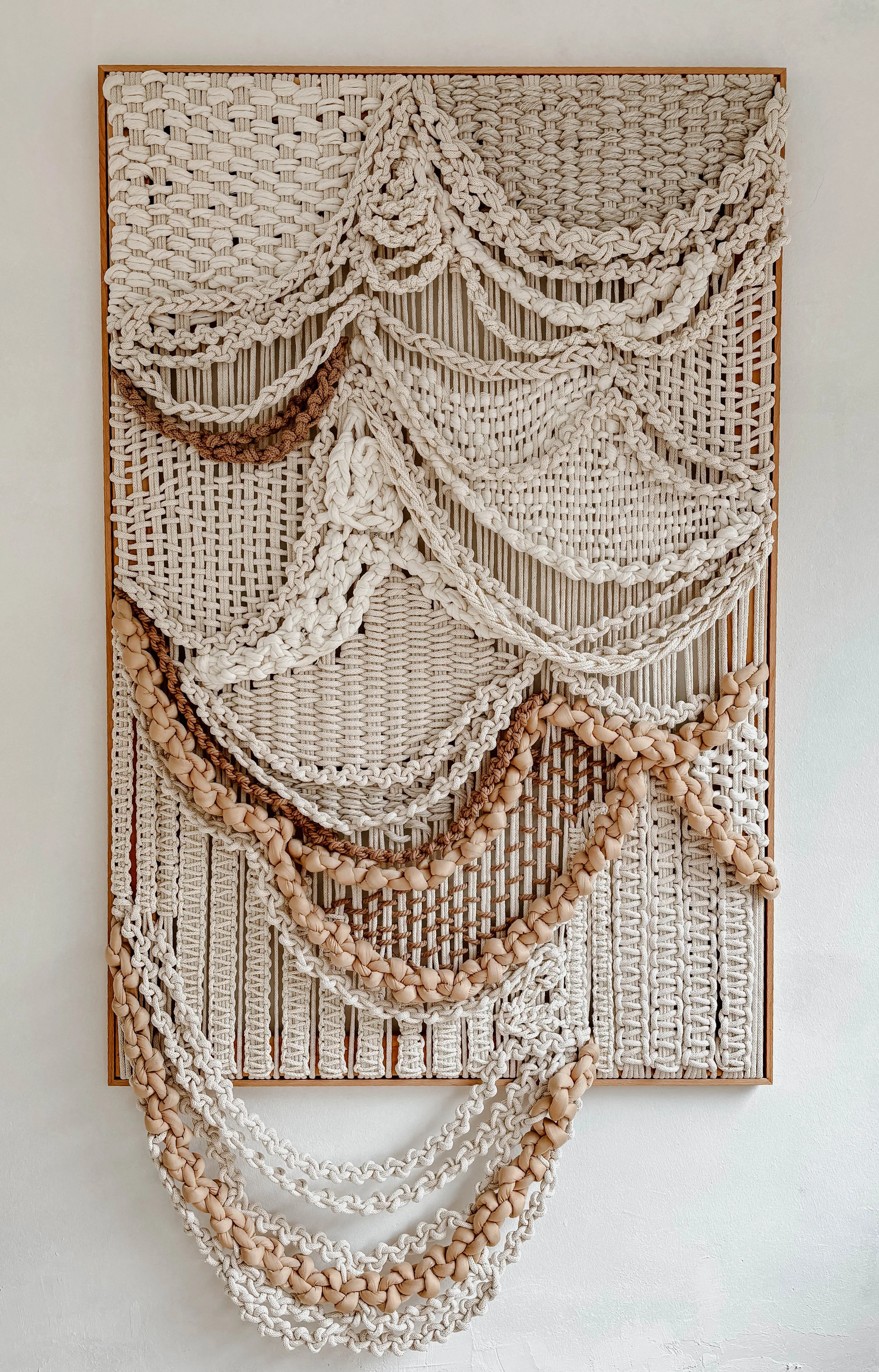 Large-scale framed textile sculpture in natural fibers with layered organic texture for luxury interior spaces