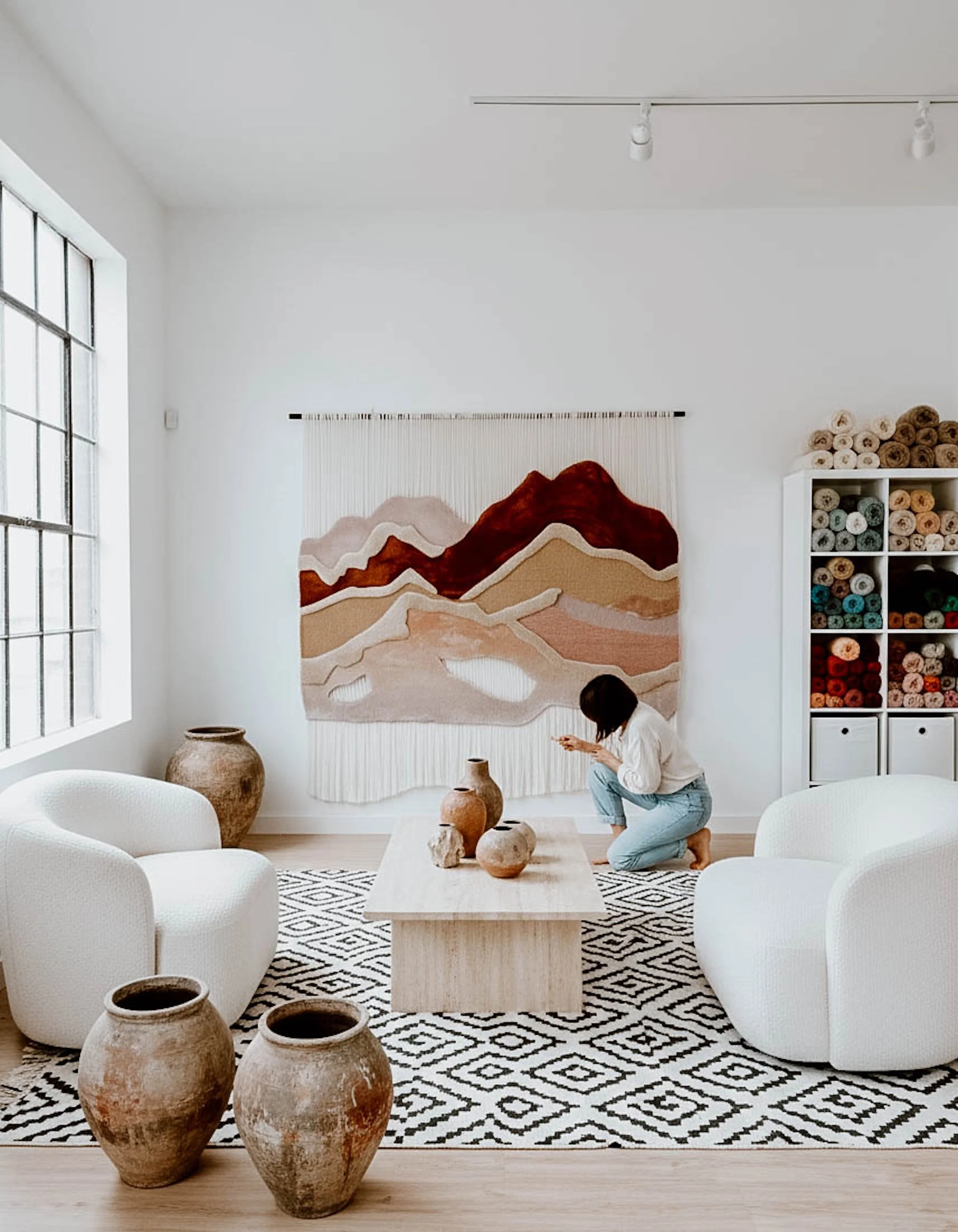Serenity Peaks hand-tufted textile wall installation featuring layered mountain-inspired shapes in warm earthy tones with cascading fiber backdrop.