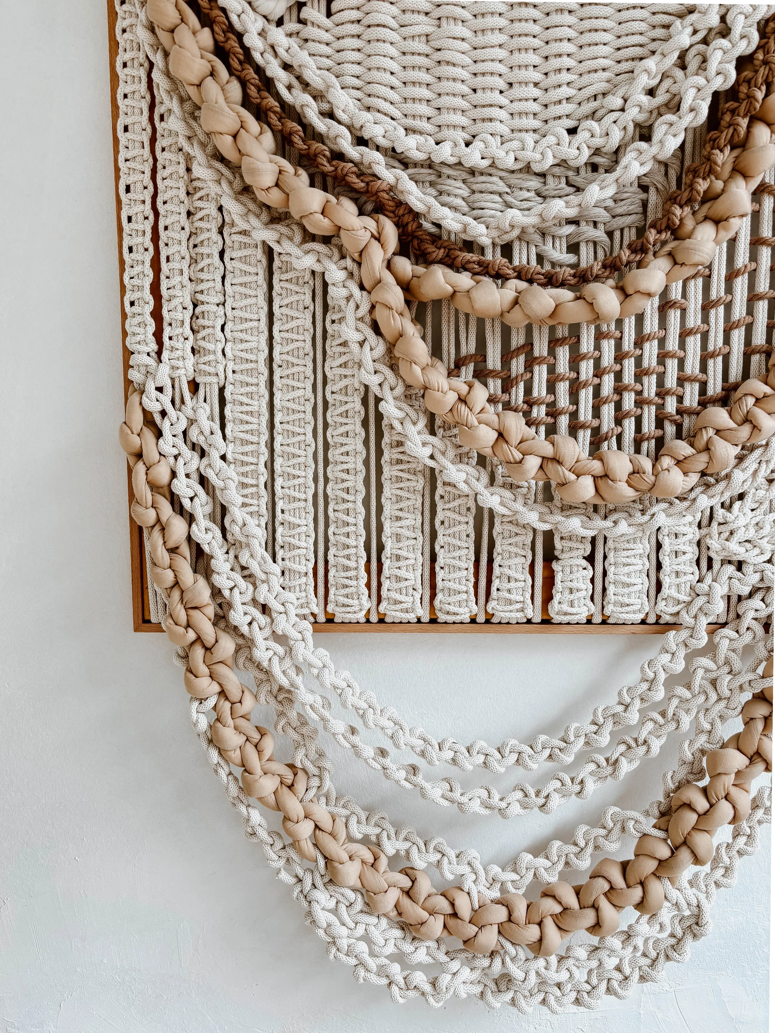Large-scale framed textile sculpture in natural fibers with layered organic texture for luxury interior spaces