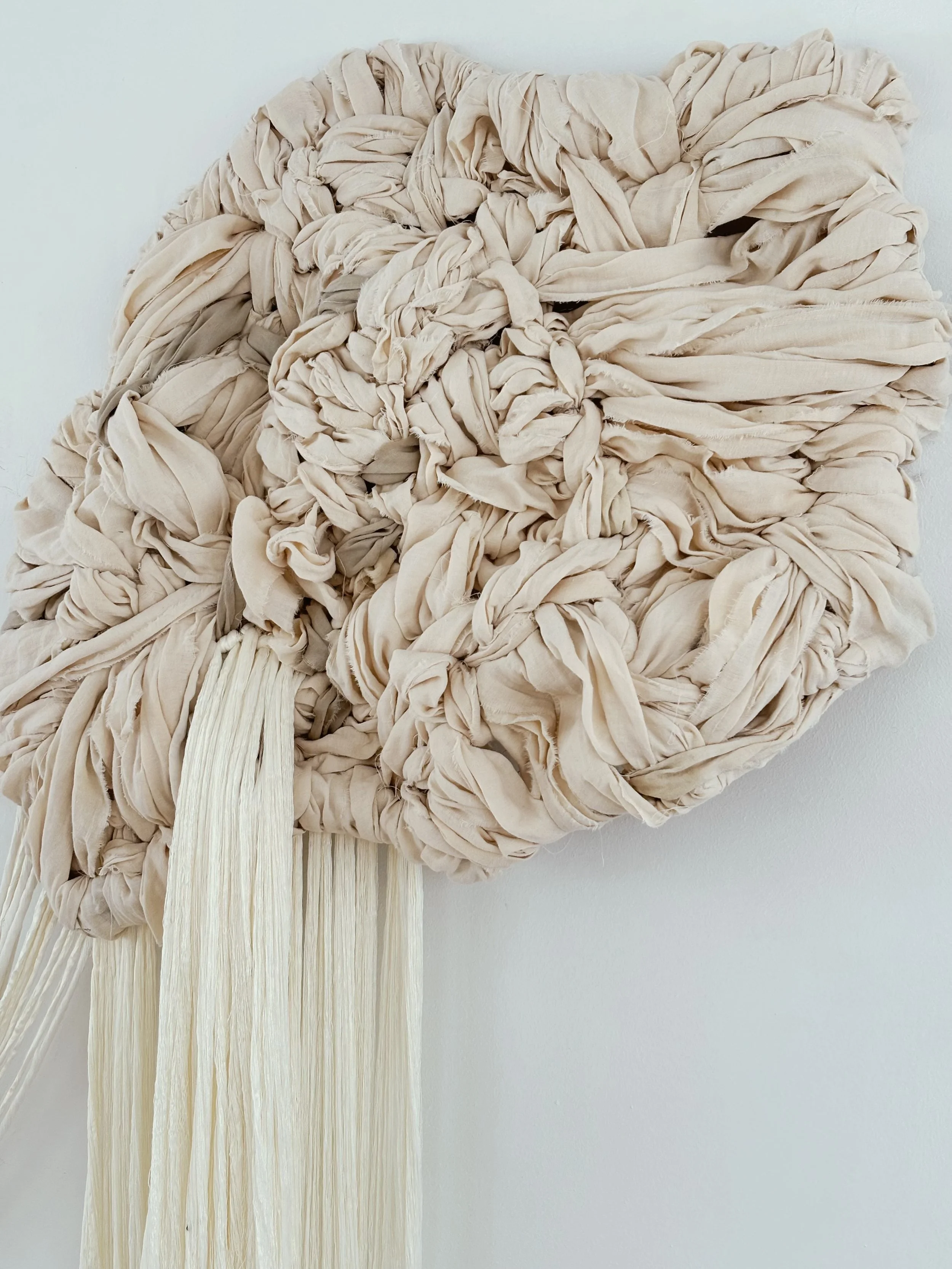 Hand-tufted contemporary textile wall sculpture with organic floating forms and soft fiber texture designed for interior architectural spaces.