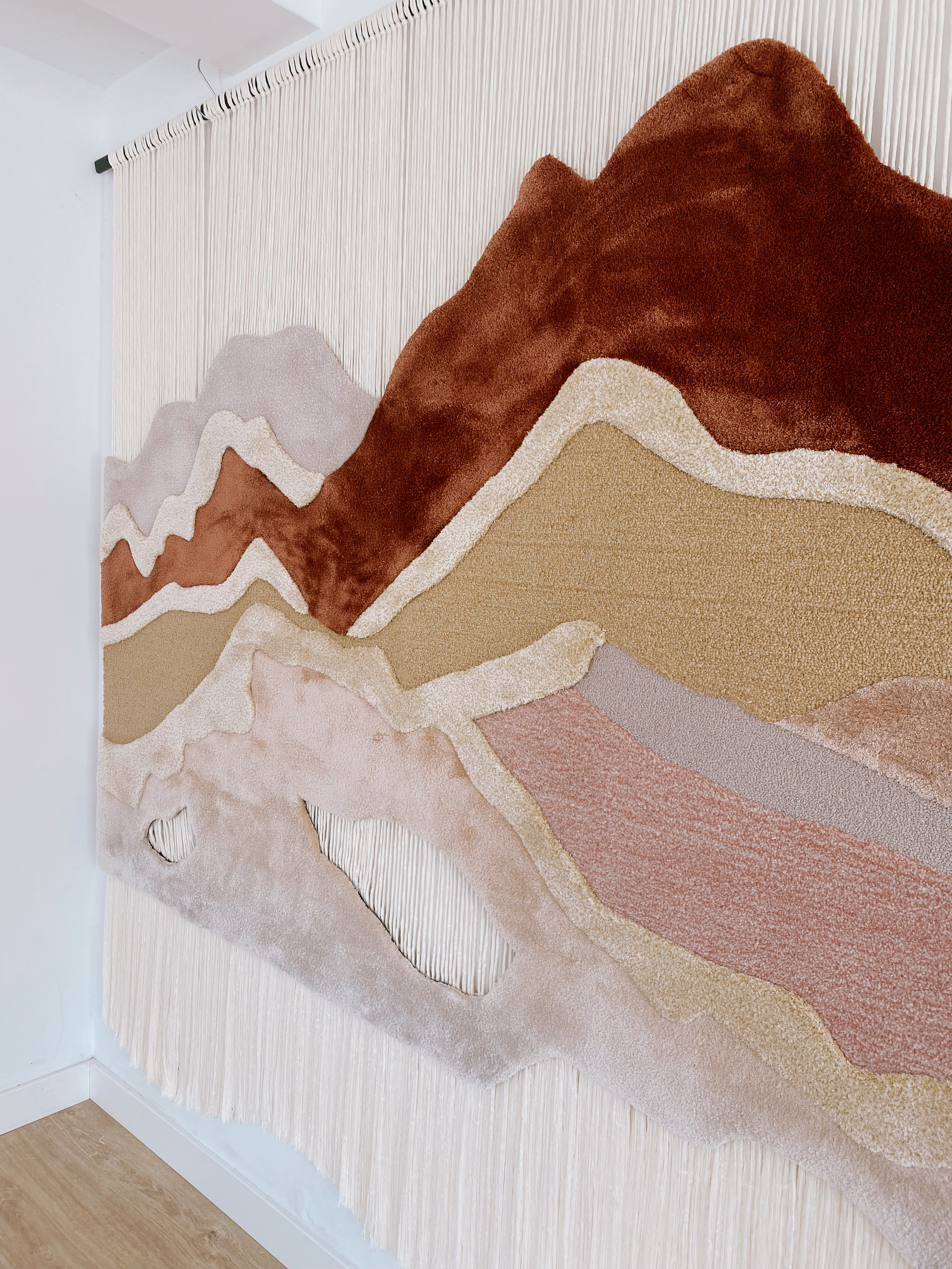 Close-up of Serenity Peaks textile artwork showing tonal transitions, raised tufted surfaces and soft organic contours.