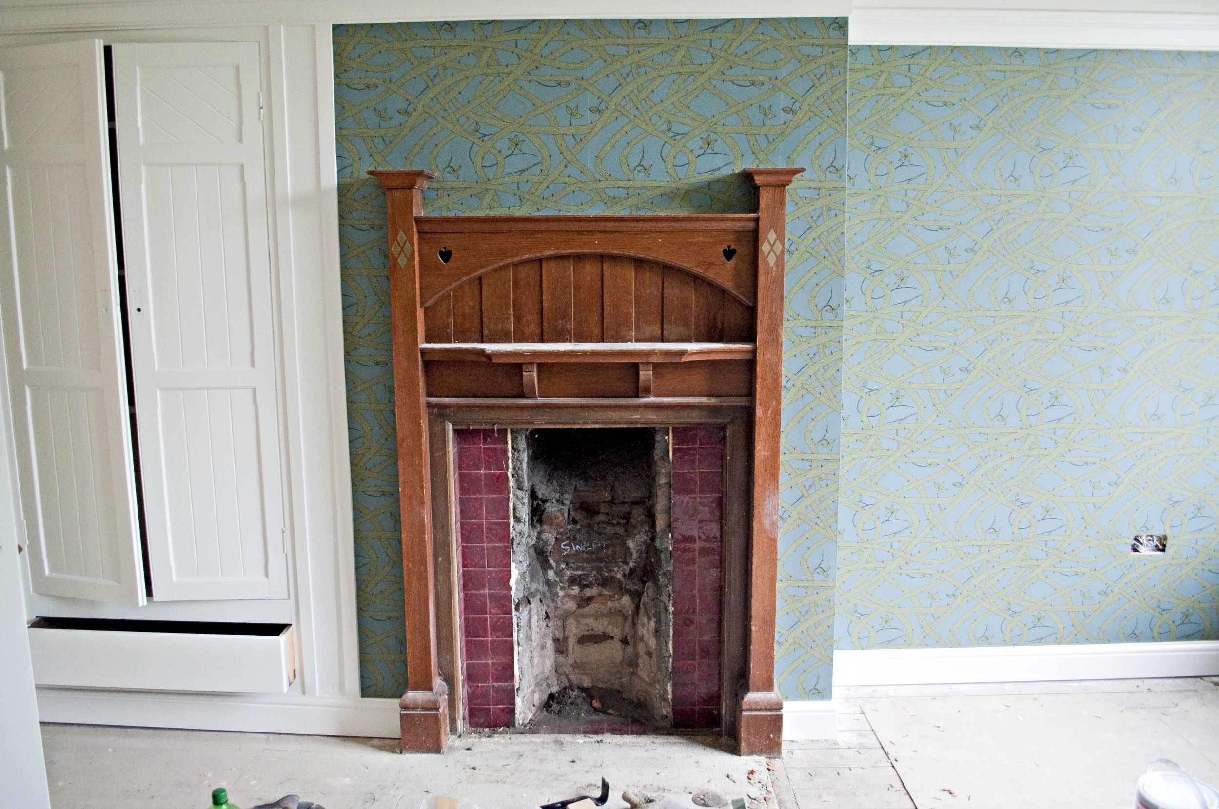 We've got a bedroom decorated...and we've uncovered the original fireplace tiles