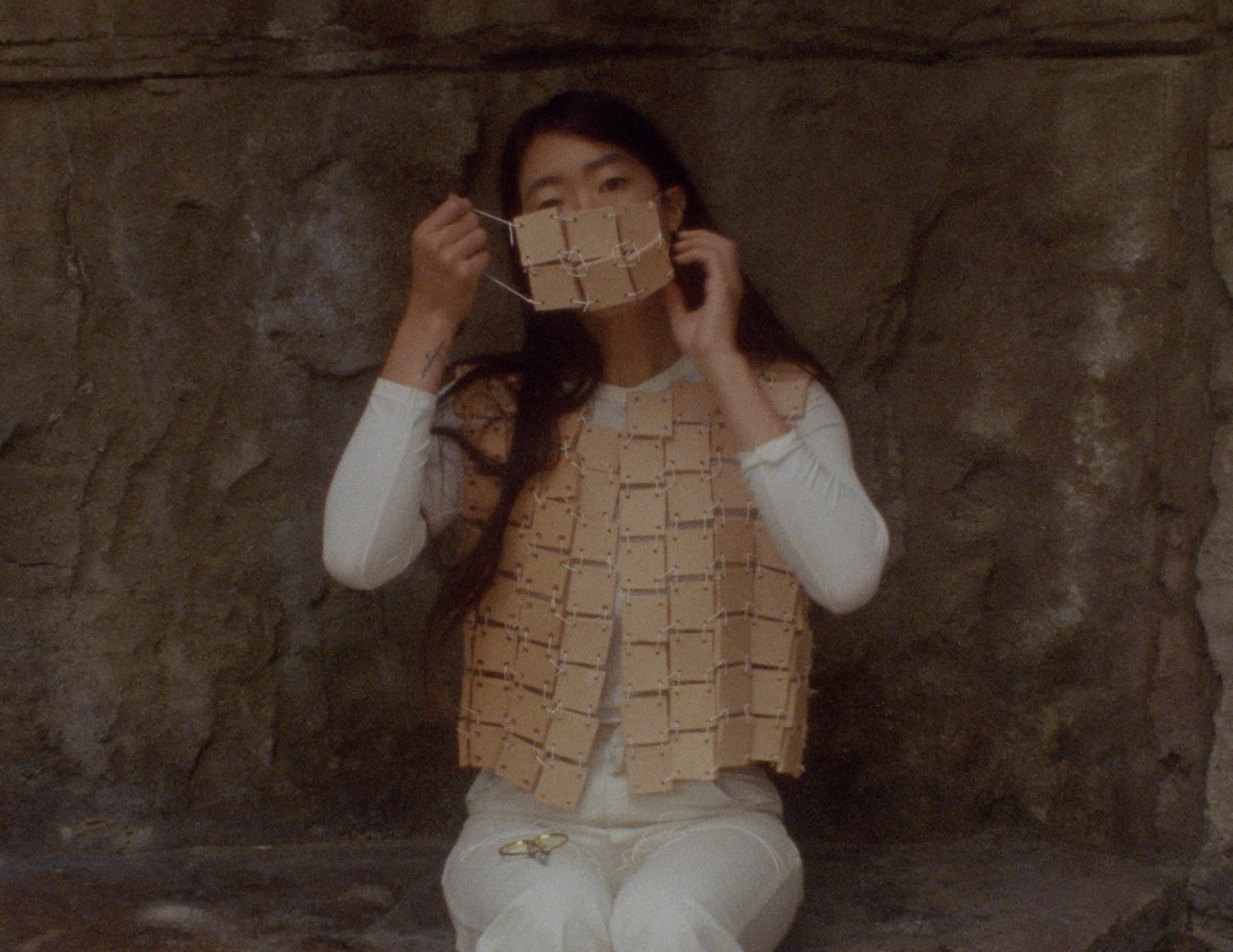 self armature iii (at the Los Angeles Police Academy rock garden above the shooting range) (still) , 2019, 16mm film transferred to digital, sound, clay