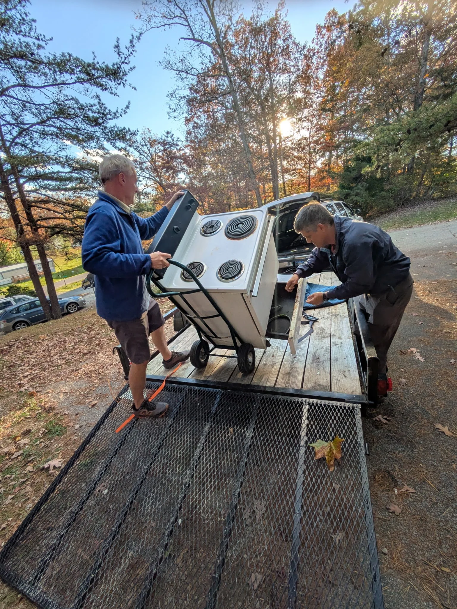 Loading an old, broken stove to haul off