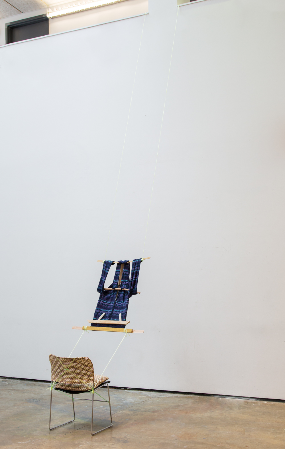  Loom, 2014, hoodie, plastic chord, wood, custom Banig-print fabric chair covering, Yale critique chair, 240 x 20 x 20 inches 