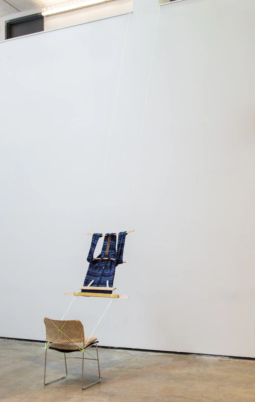 Loom, 2014, hoodie, plastic chord, wood, custom Banig-print fabric chair covering, Yale critique chair, 240 x 20 x 20 inches
