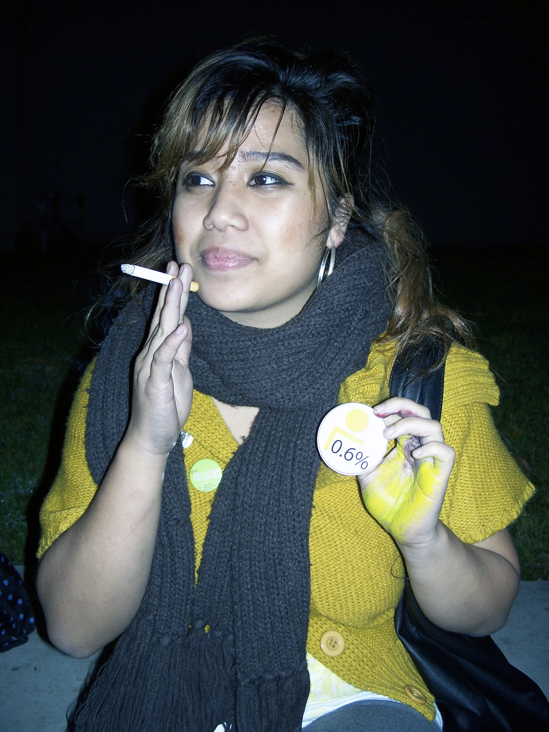 Undergraduate student posing with "0.6%" button 
