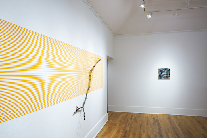   Orange Stick II (41.8441 ° N, 71.4382 ° W)   2017  masking tape and found sticks  144” x 432” x 16”  Image courtesy of Providence College Galleries (PC-G) 