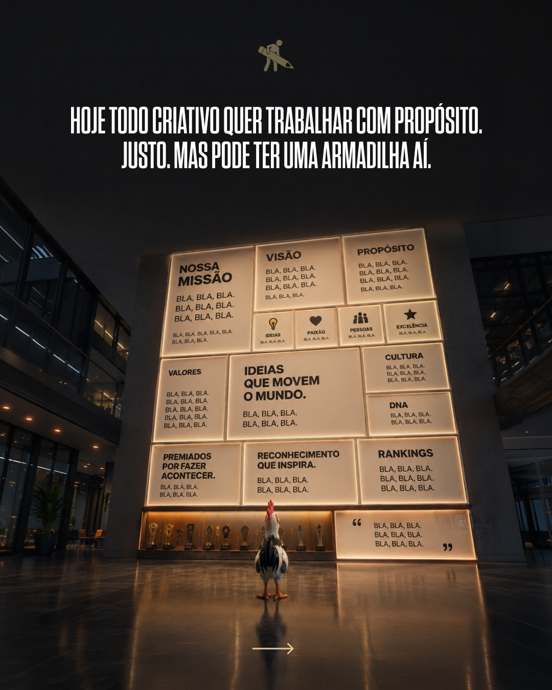 A rooster standing on the floor in front of a large illuminated wall display with various inspirational phrases written in Portuguese. The wall features awards and icons representing values, vision, purpose, and recognition.