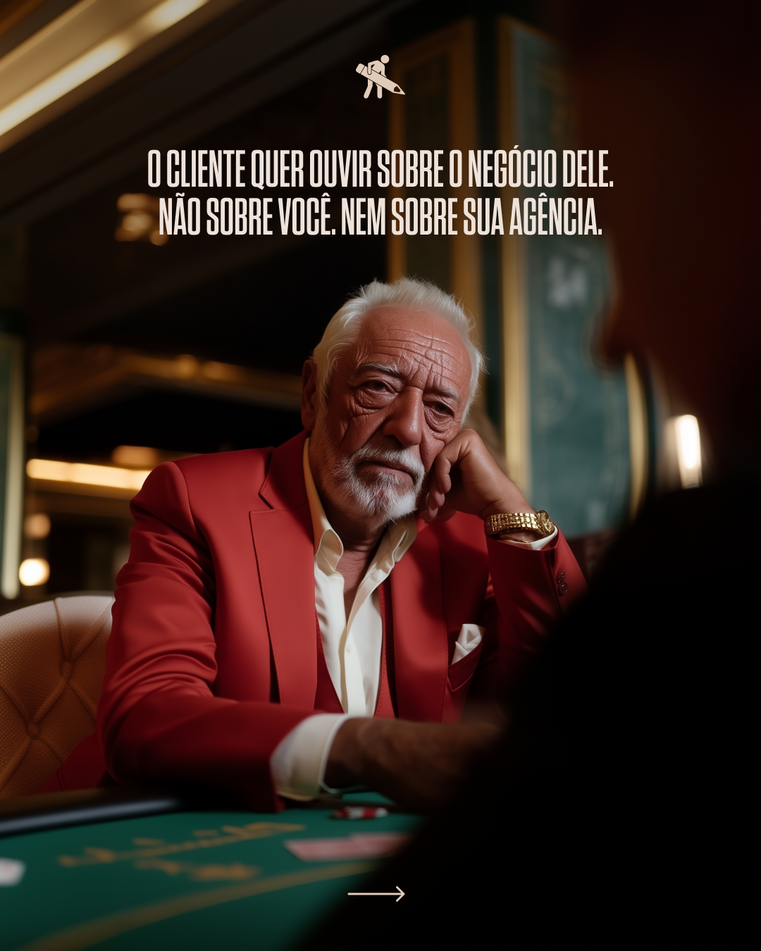 An elderly man with white hair and beard, dressed in a red blazer and white shirt, sitting at a poker table in a casino or similar setting, appearing serious and contemplative.
