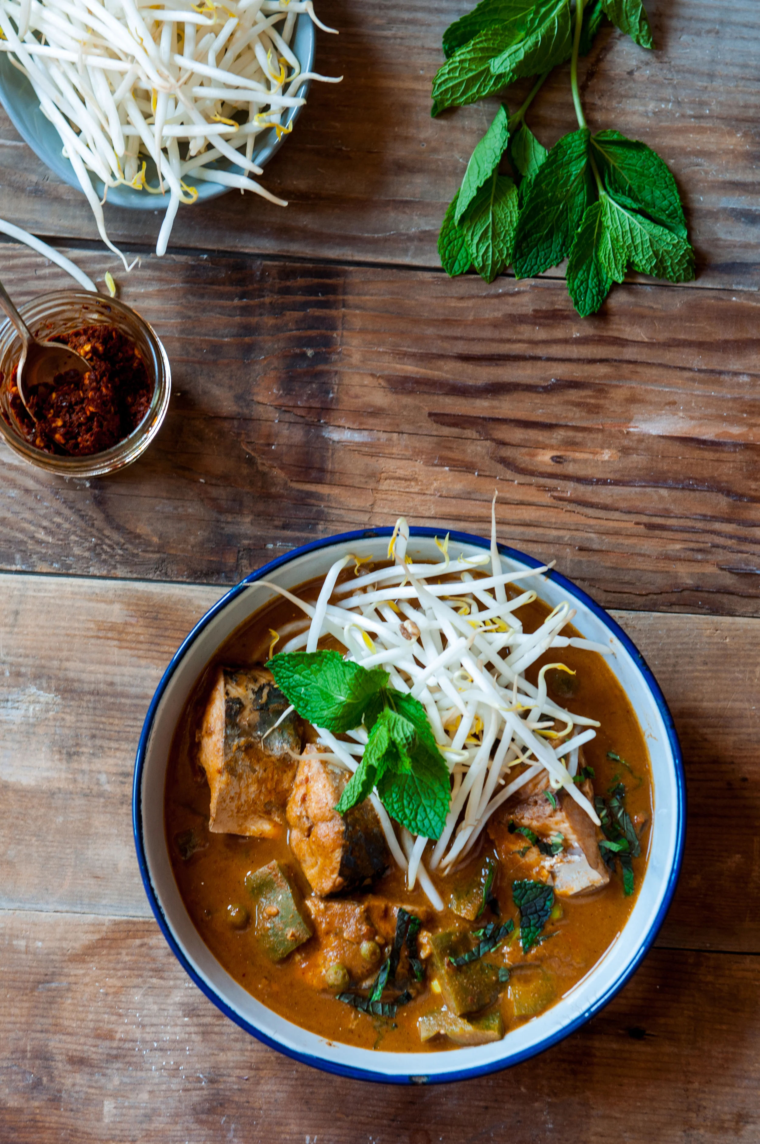 The curry is reminiscent of the several variations of fish curry you will find on the streets in Asia. Mine here is a confluence of South Asian and East Asian flavors with the curry spiced with roasted whole spices, lemongrass and topped with the crunch of bean sprouts and mint. Although, usually served with rice in most cultures, in South India, it is also eaten with rice and bean pancakes. So, I served it thus, with sprouted mung bean and rice yeasted pancakes.