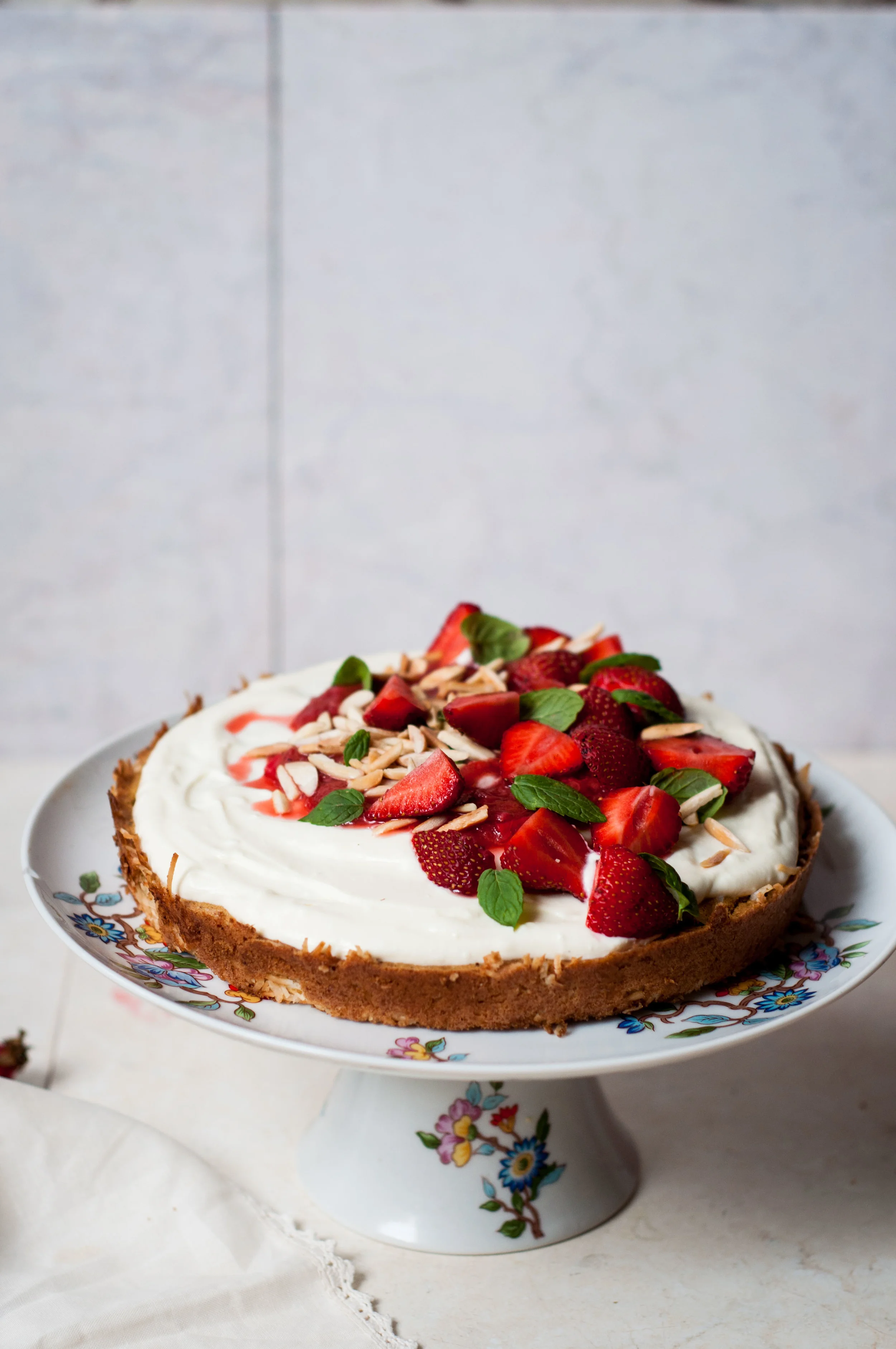 Gluten free oat, almond and coconut sponge with honeyed strained yogurt topped with rhubarb-strawberry compote and fresh strawberries from the market.