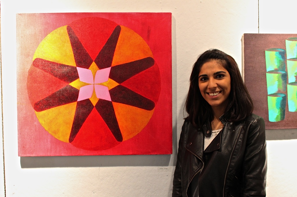 Misha Sumar '16 stands next to her work