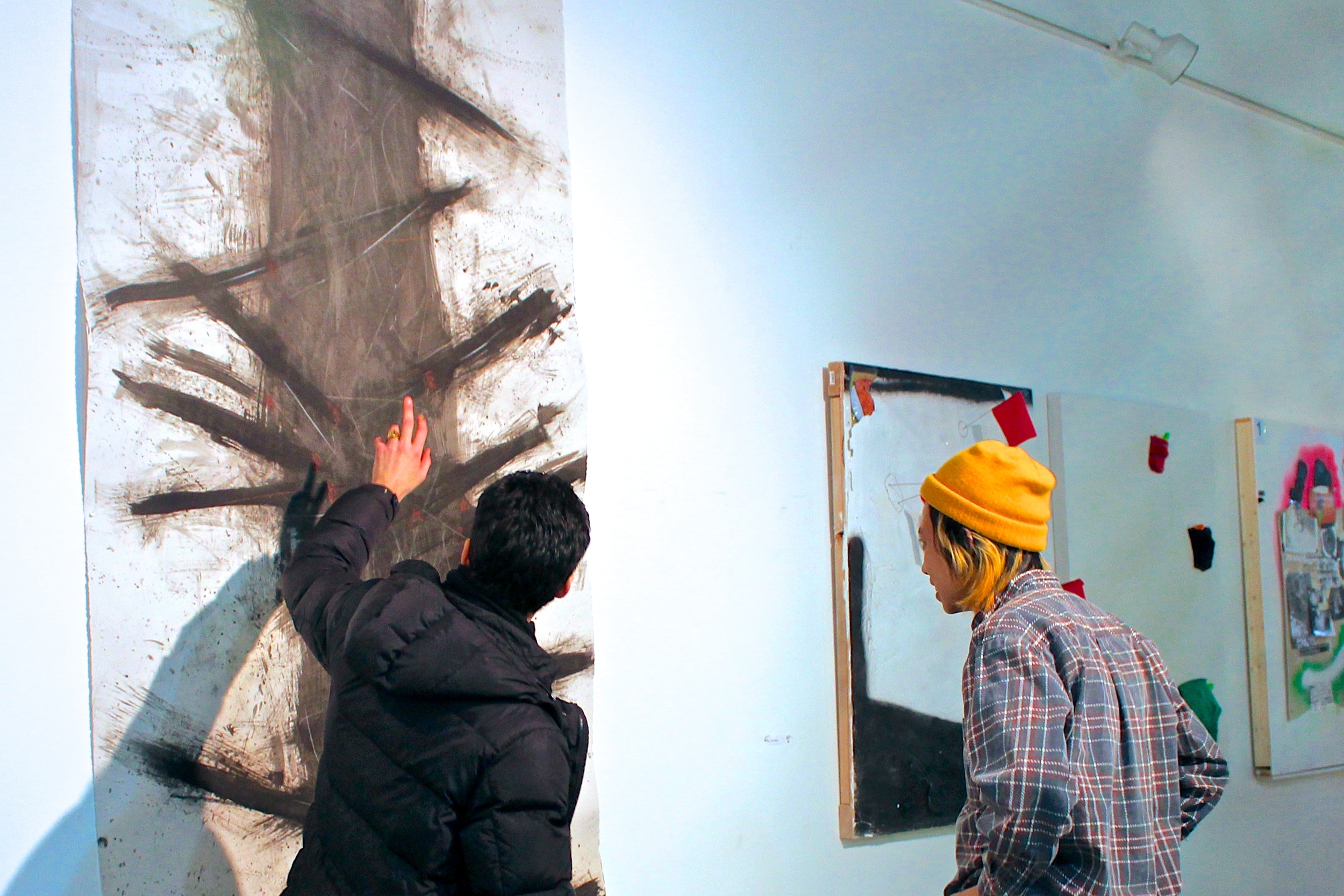 Alexis de Chaunac '14 explains his work as Tuyên Nguyễn '17 looks on