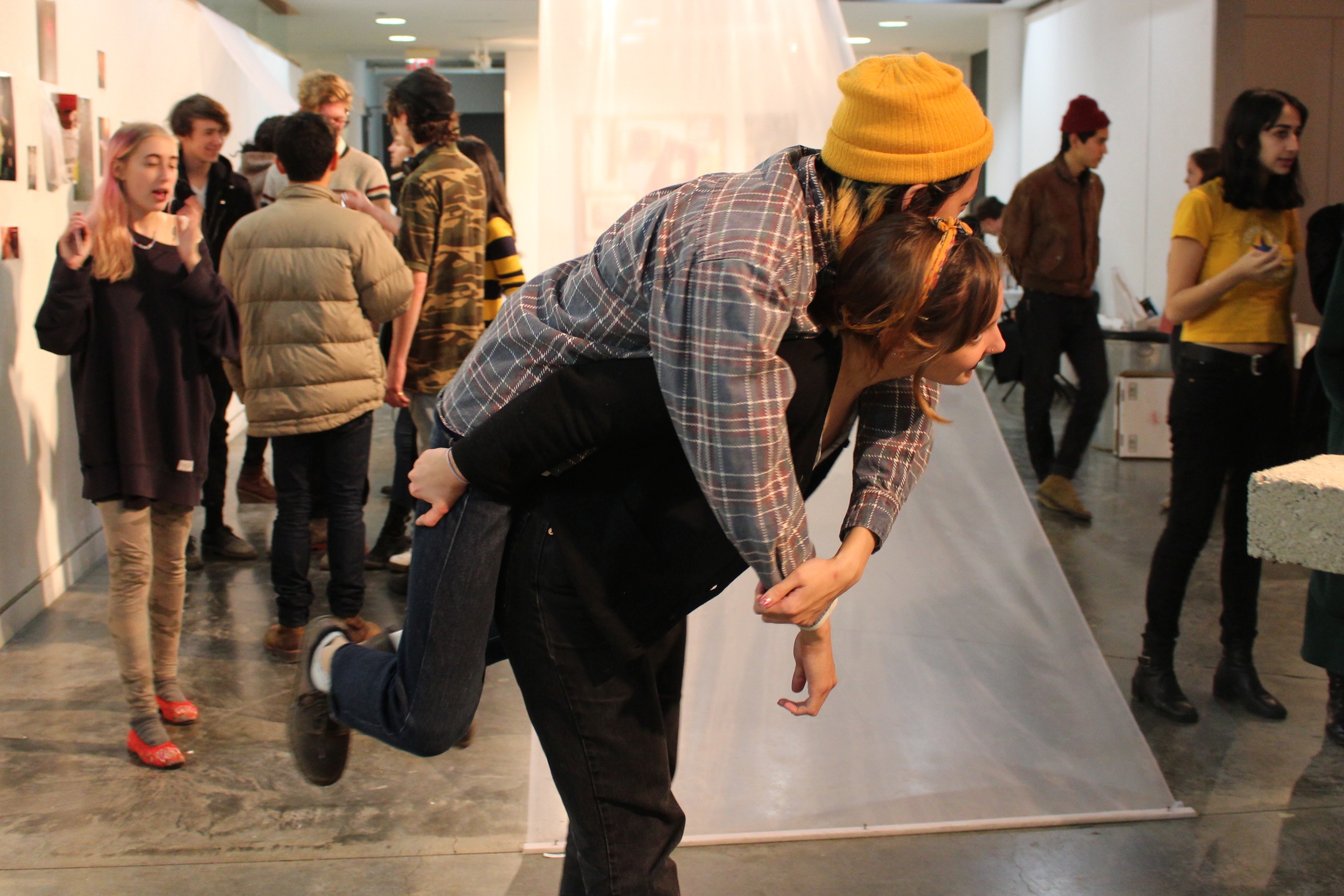 Tuyên Nguyễn '17 hitches a ride with Emma Sadowski '15 at a recent exhibition of student work in Heimbold Visual Arts Center.