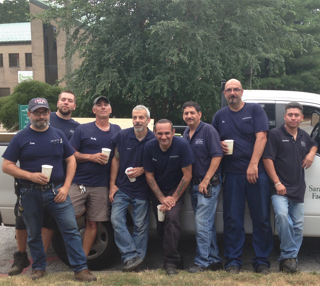 Facilities workers gathered in front of one of the department vans. Photo by Janaki Chadha '17