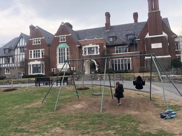 Seniors Em Hammett and Annie Friedman on the swings for the last time. Credit: Ceylan Swenson