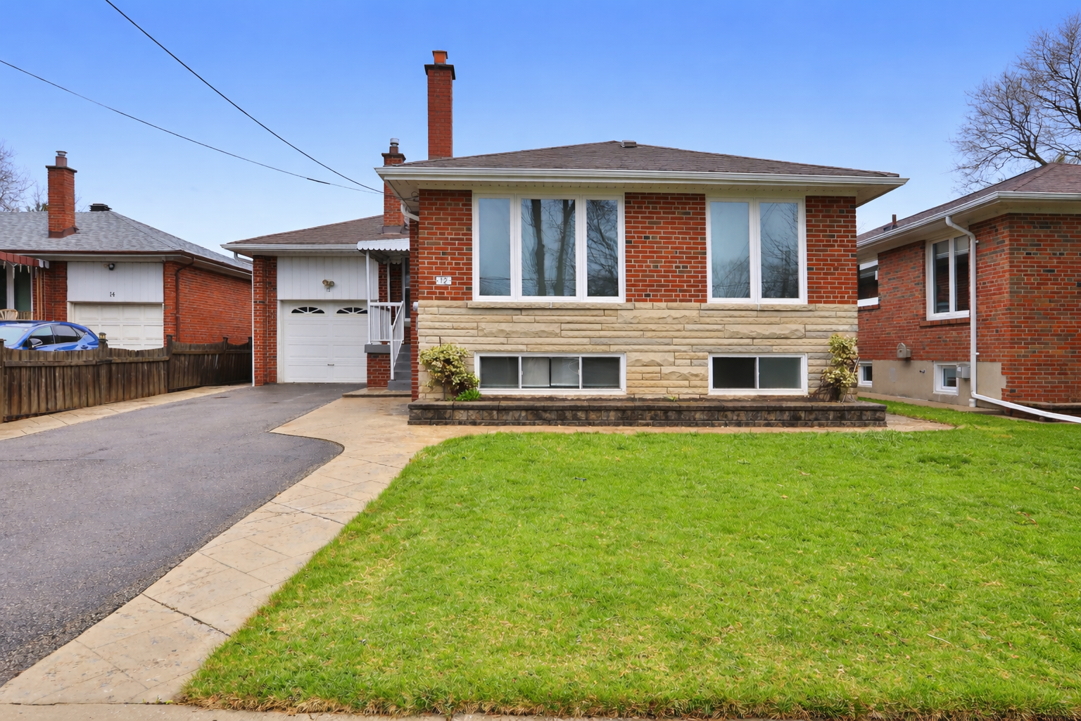 Red brick house under clear sky.png