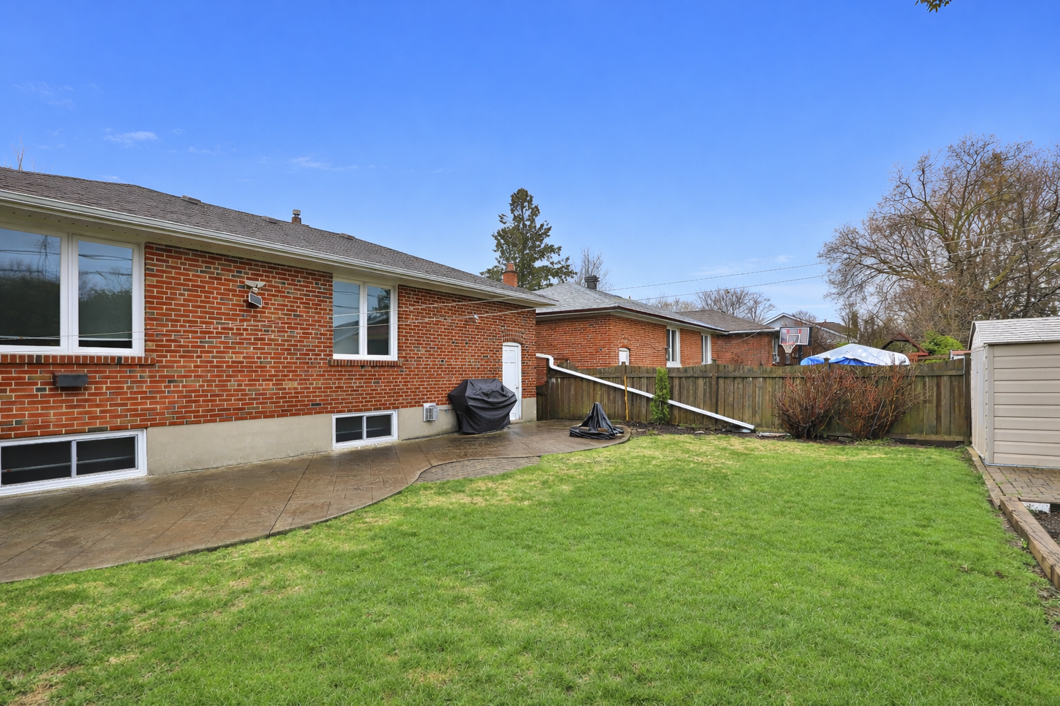 Suburban backyard with stamped concrete patio.png