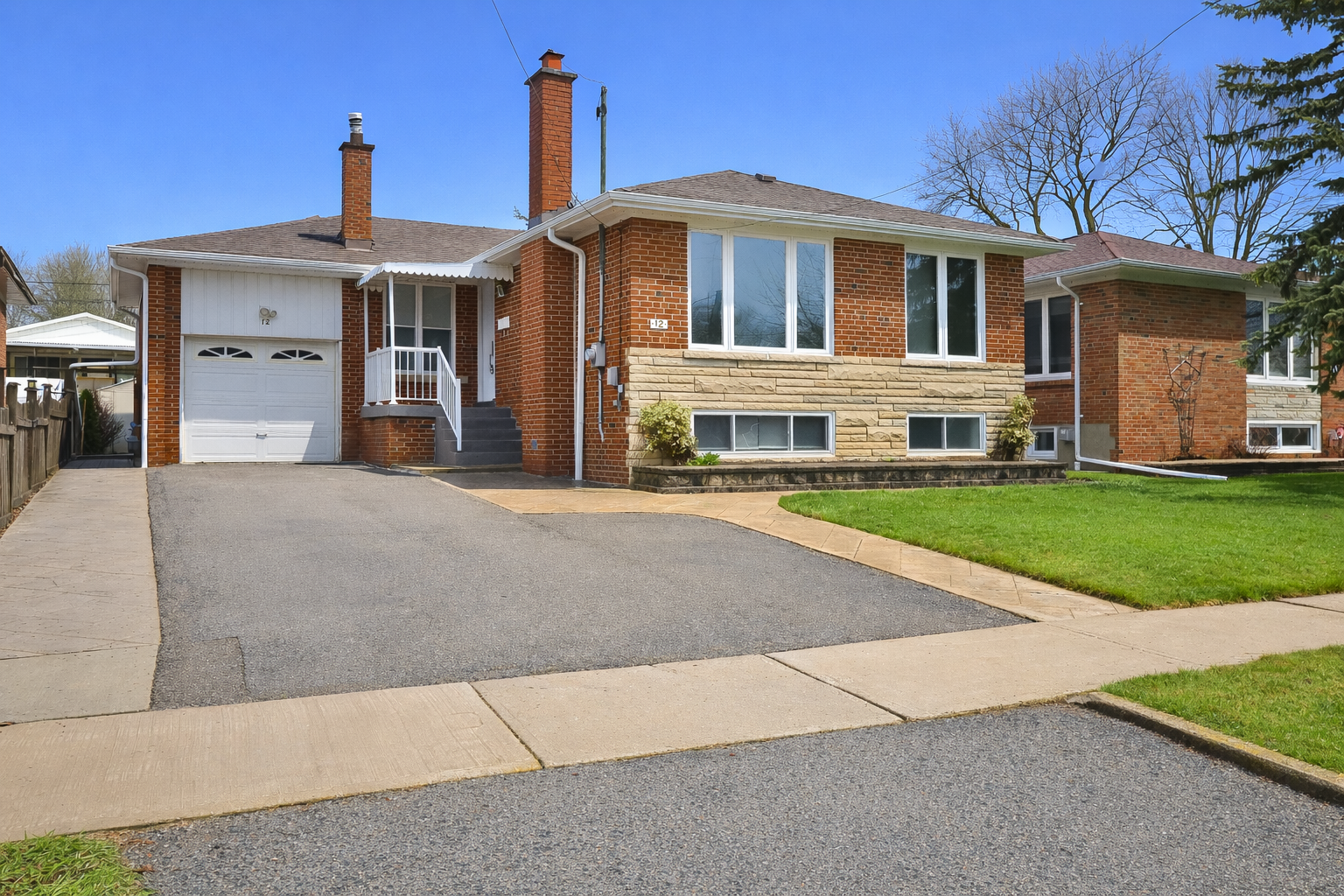 Sunny suburban home with green lawn.png