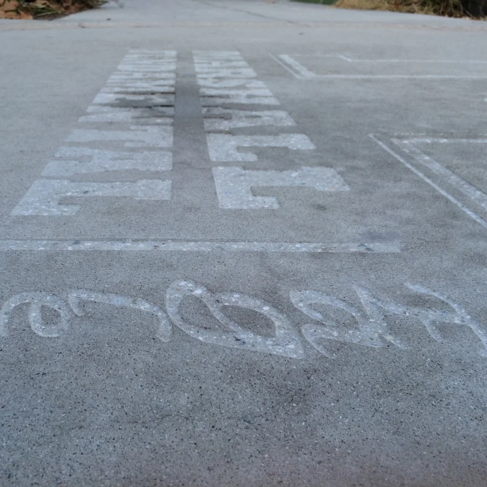 Close up of High School Logo on existing concrete