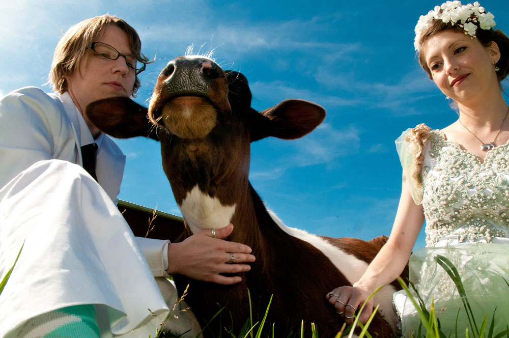 Dani & Laura were married at Farm Sanctuary in Watkins Glen, NY and celebrated with some cuddle time with the amazing young steer named Michael . Their wedding was featured in the 2014 VegNews Wedding Issue .