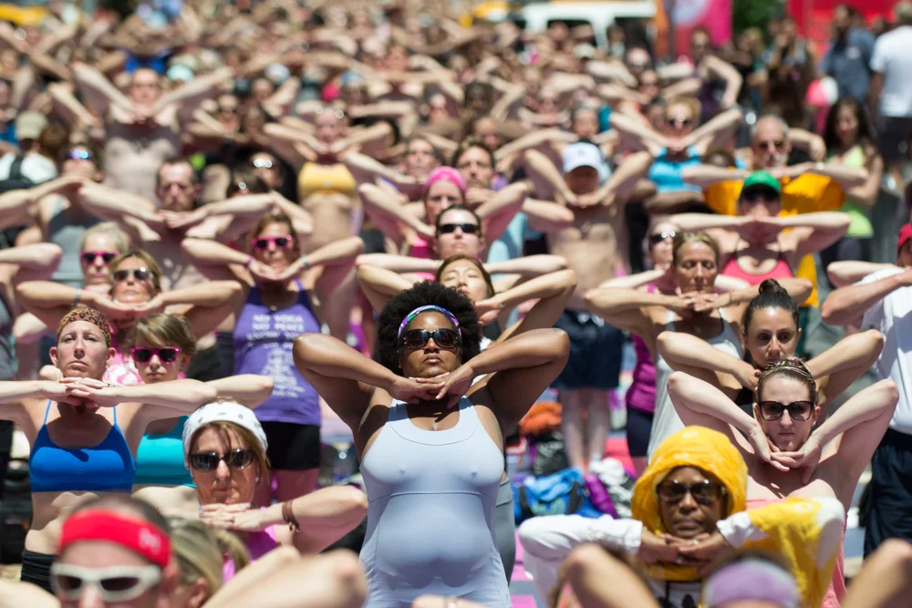 A sea of yogis practicing Bikram Yoga at the Solstice in Times Square