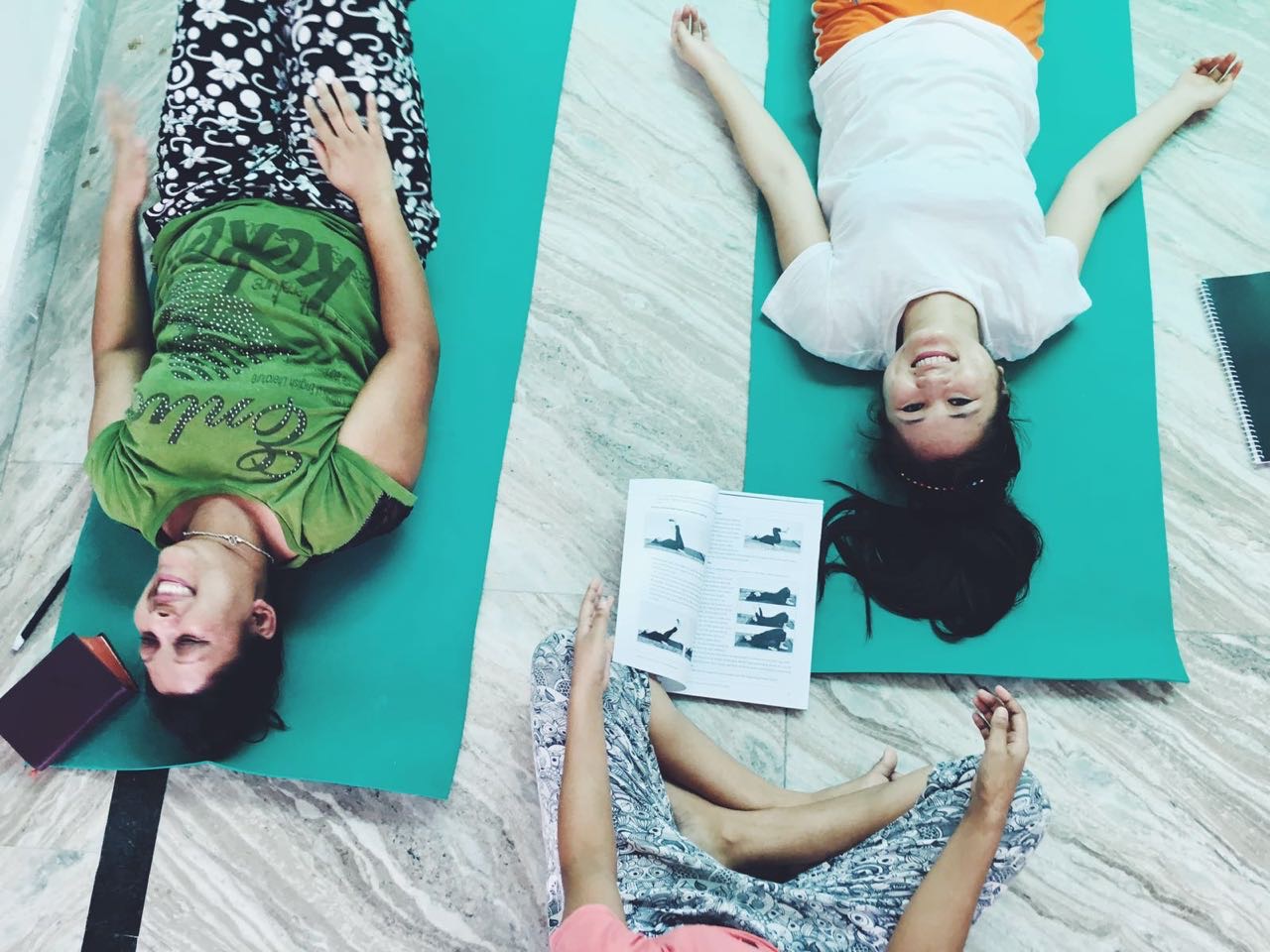 Staff practicing their new yoga skills with each other