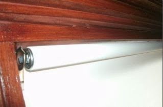 Roller shade mechanisms have been totally redesigned and engineered for carefree operation and longevity. If you like or need a cordless option, the new version of the spring roller operates much like the great soft-close drawers you have seen in the latest kitchens. A gentle tug releases the shade and it slowly raises itself to the rolled up position. You can also hold on to the shade to stop it mid way at any point. To lower it, just pull it down. The benefit of these shades are they are cordless and therefor child safe. This is what the mechanism that hides behind a short fabric valance looks like, but you'll never see it from outside or inside.