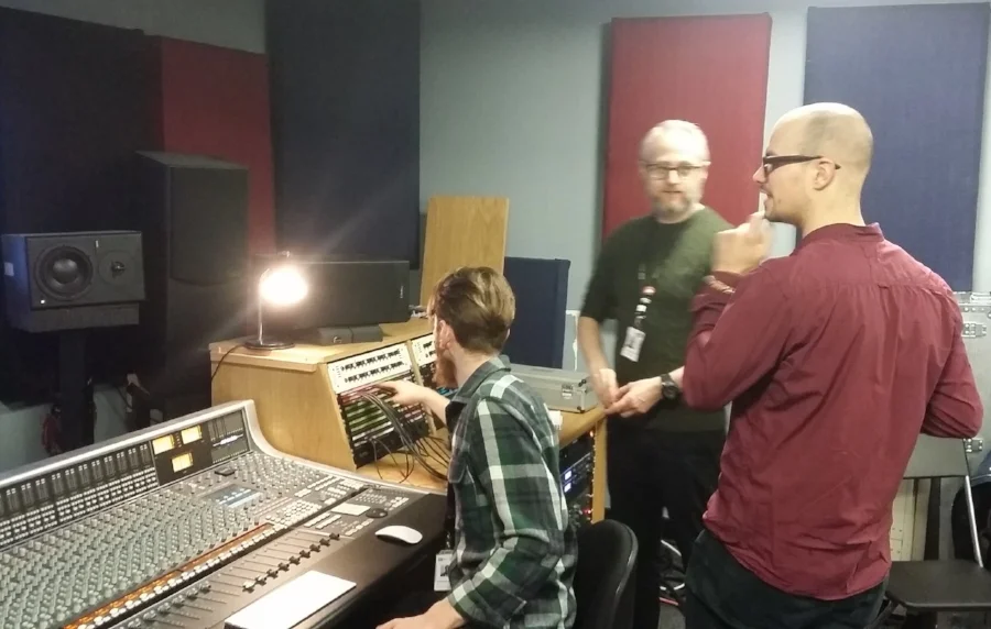 Carry (bass) and (college tutor) James discuss recording technique while Chris (student producer!) connects the patch bay