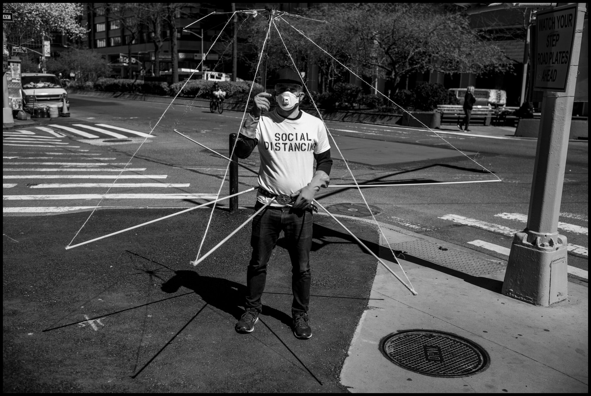  I encountered a man walking north towards Columbus Circle wearing a social distancing apparatus.  March 21, 2020. © Peter Turnley.  ID# 01-007 