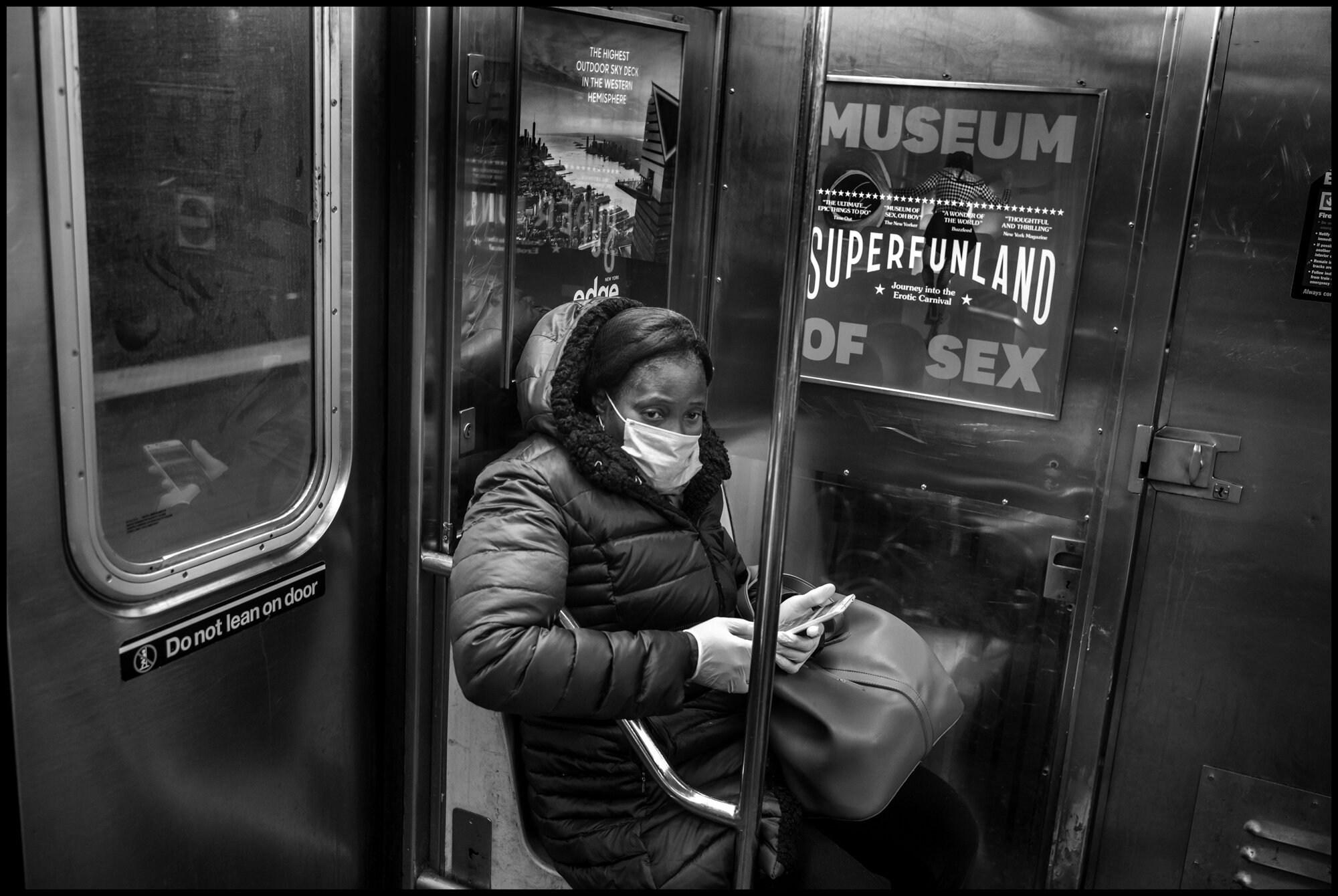  A woman rides the #1 train north.  March 21, 2020. © Peter Turnley.  ID# 01-009 