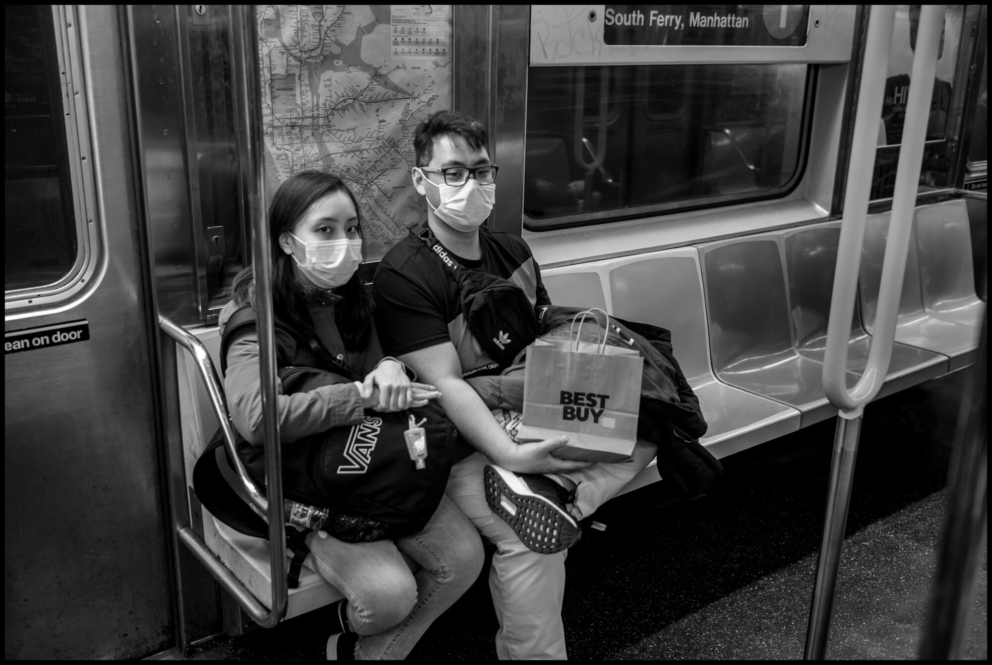  A couple returns from shopping at Best Buy on the #1 train.  March 21, 2020. © Peter Turnley.  ID# 01-011 