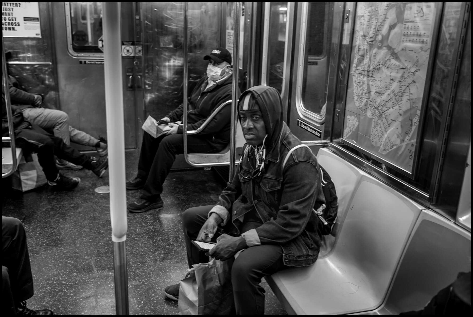  While riding the train north on the 1 Line, I encountered people wearing masks am some not. Looks of anxiety seemed to abound.  March 21, 2020. © Peter Turnley.  ID# 01-015 