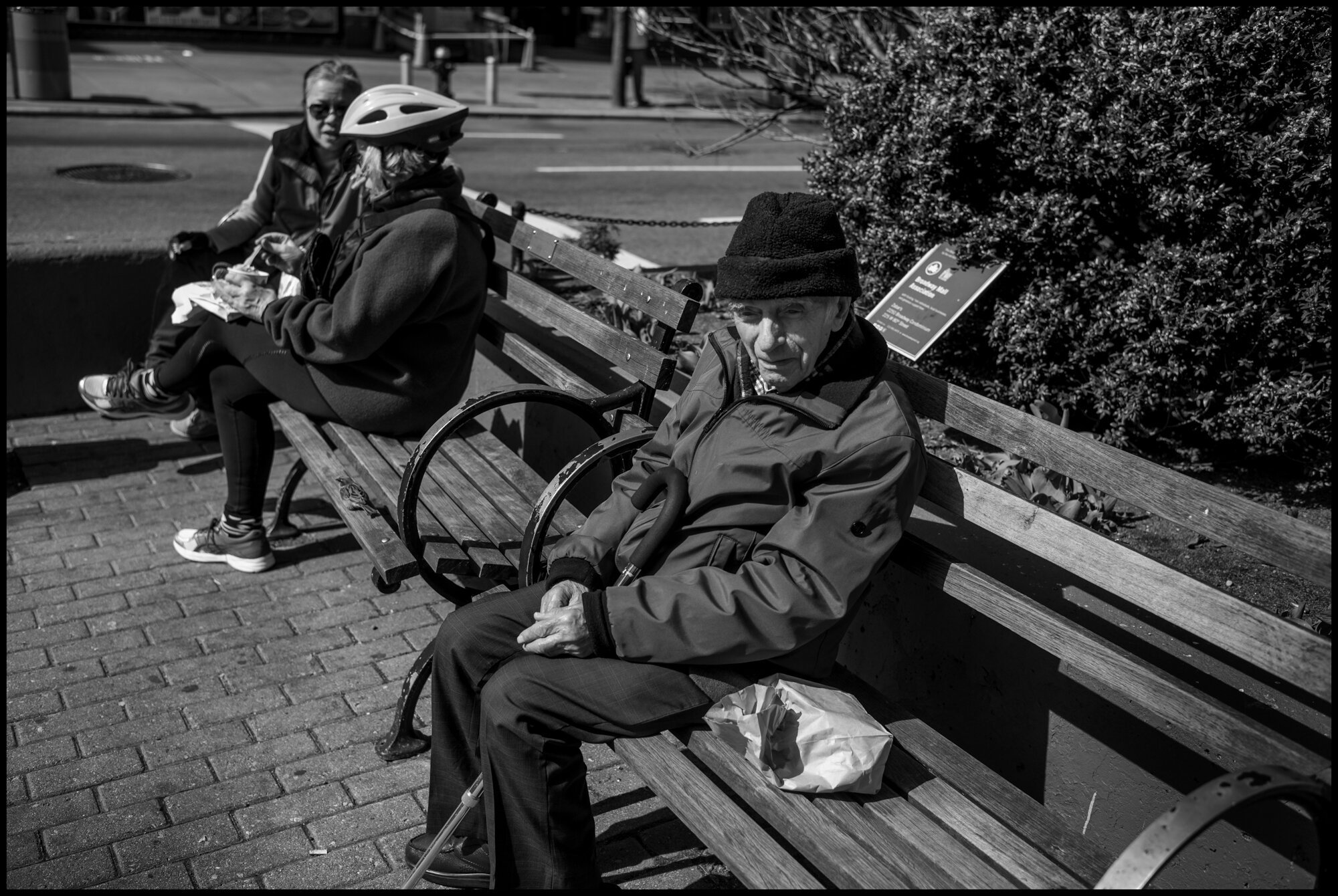  A man sits alone at the corner of 80thStreet and Broadway.  March 21, 2020. © Peter Turnley.  ID# 01-018 